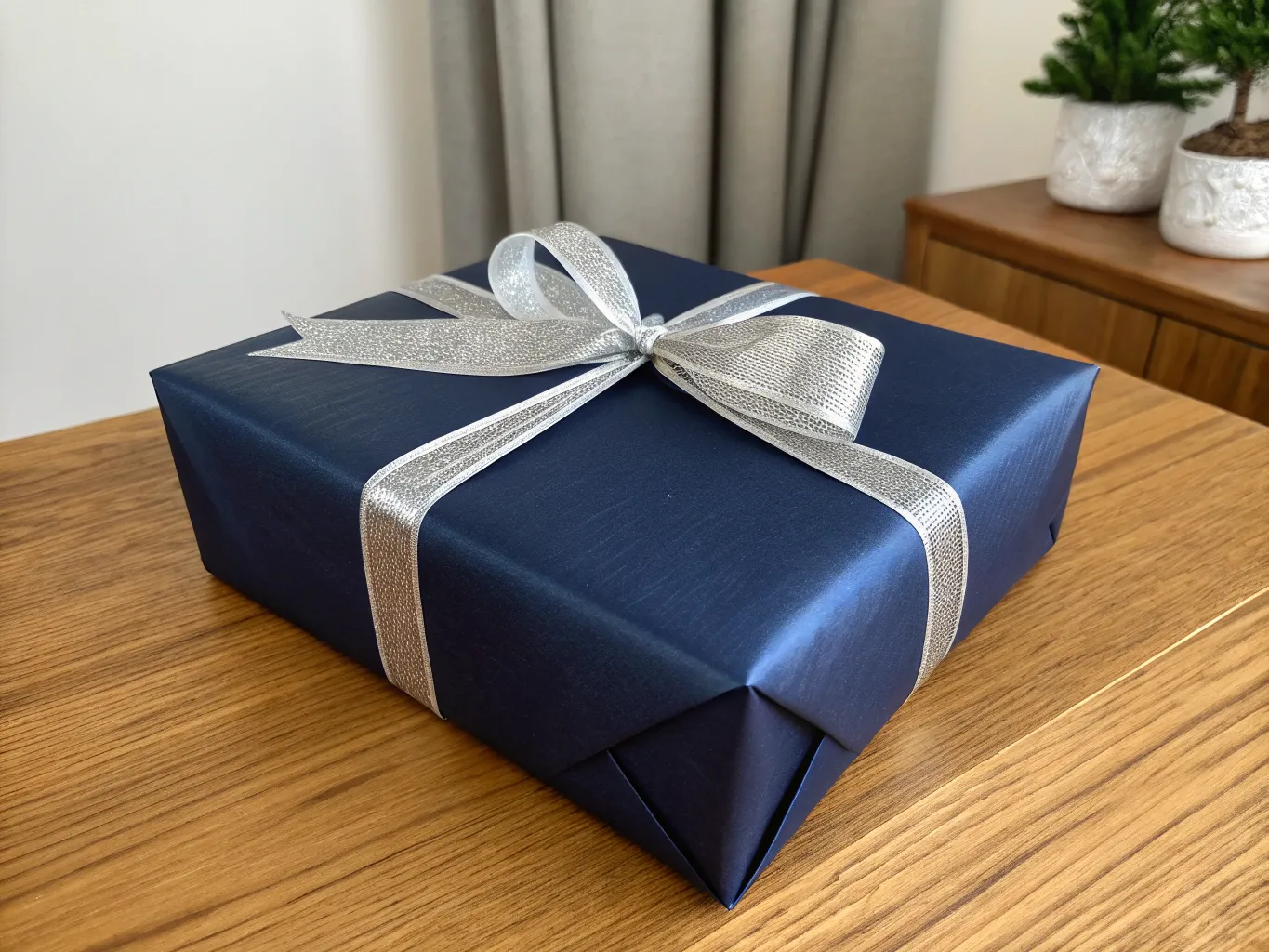 Elegant navy blue gift with silver ribbon bow